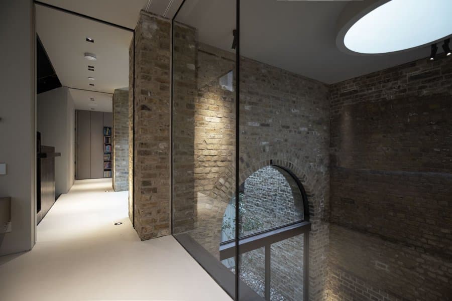 Lit hallway and threshold with recessed spots and floor washers at Station House, London